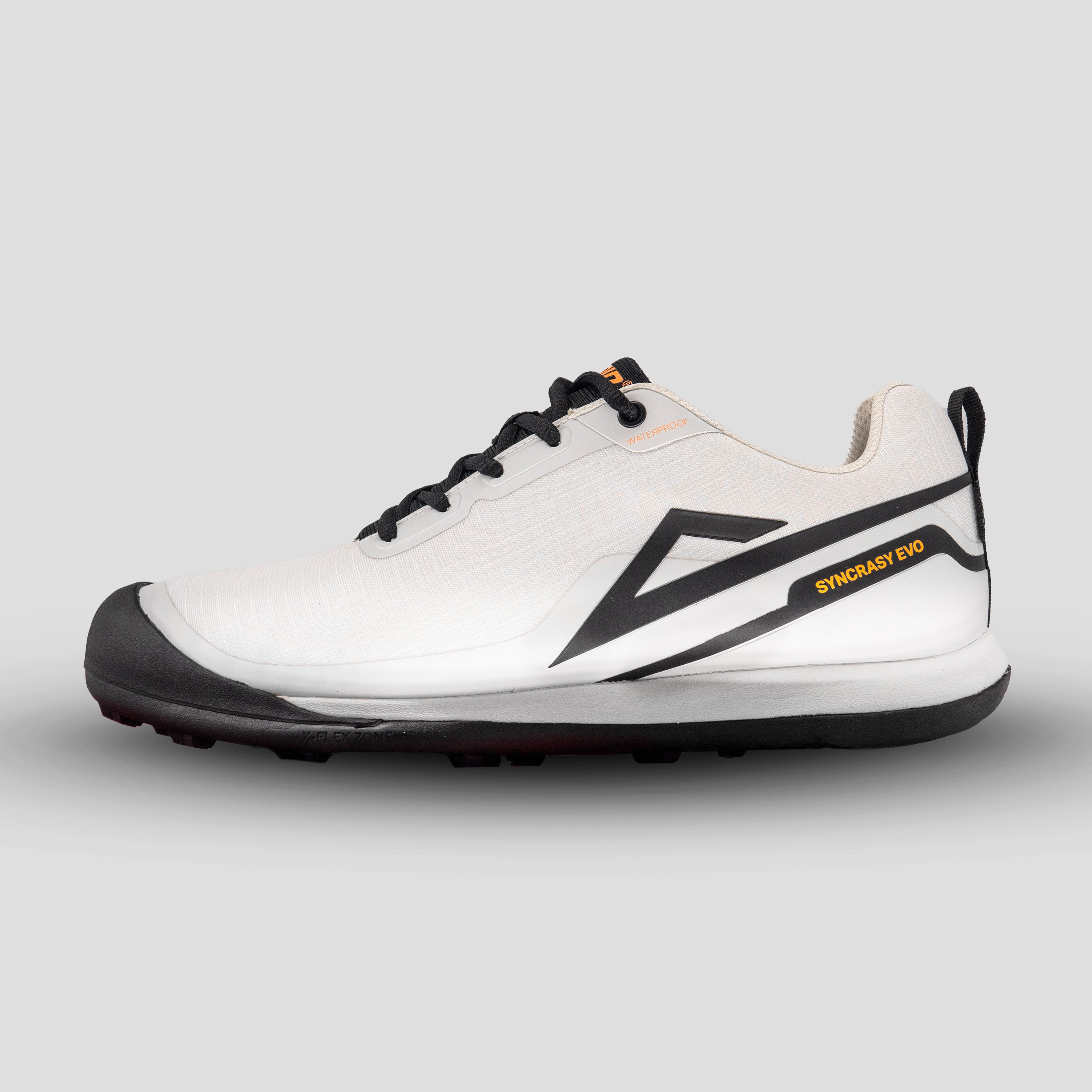 Side view of white/black disc golf shoe